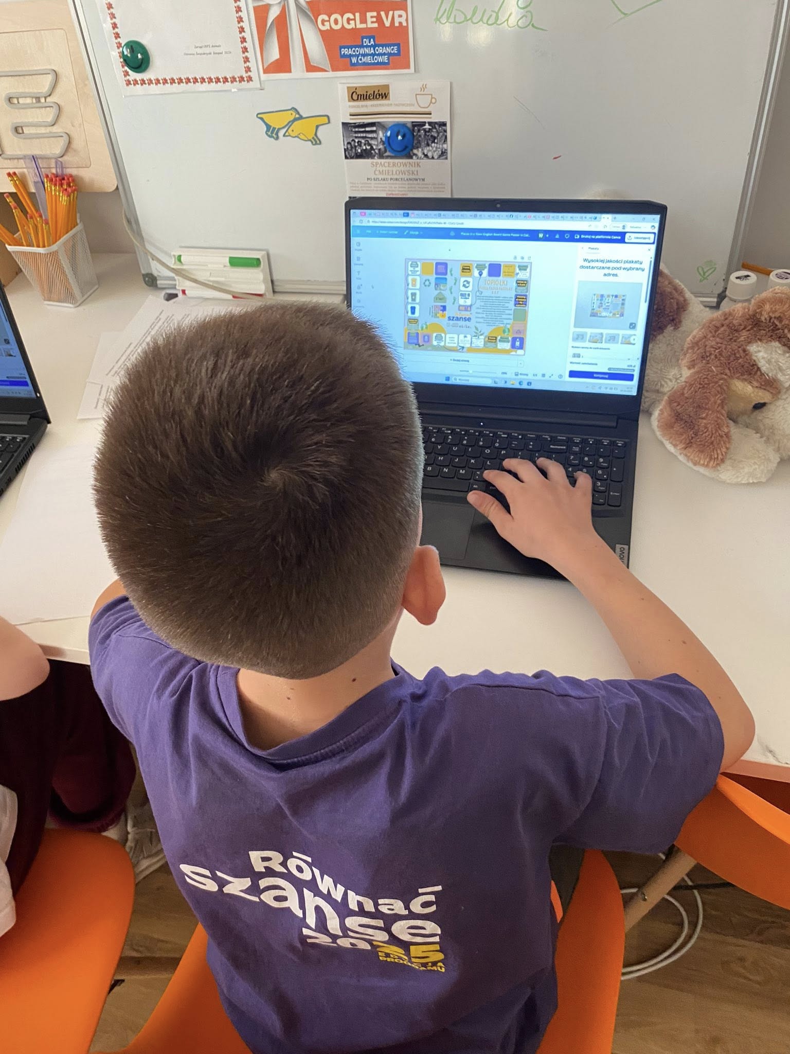 zdjęcie chłopca grającego przy laptopie