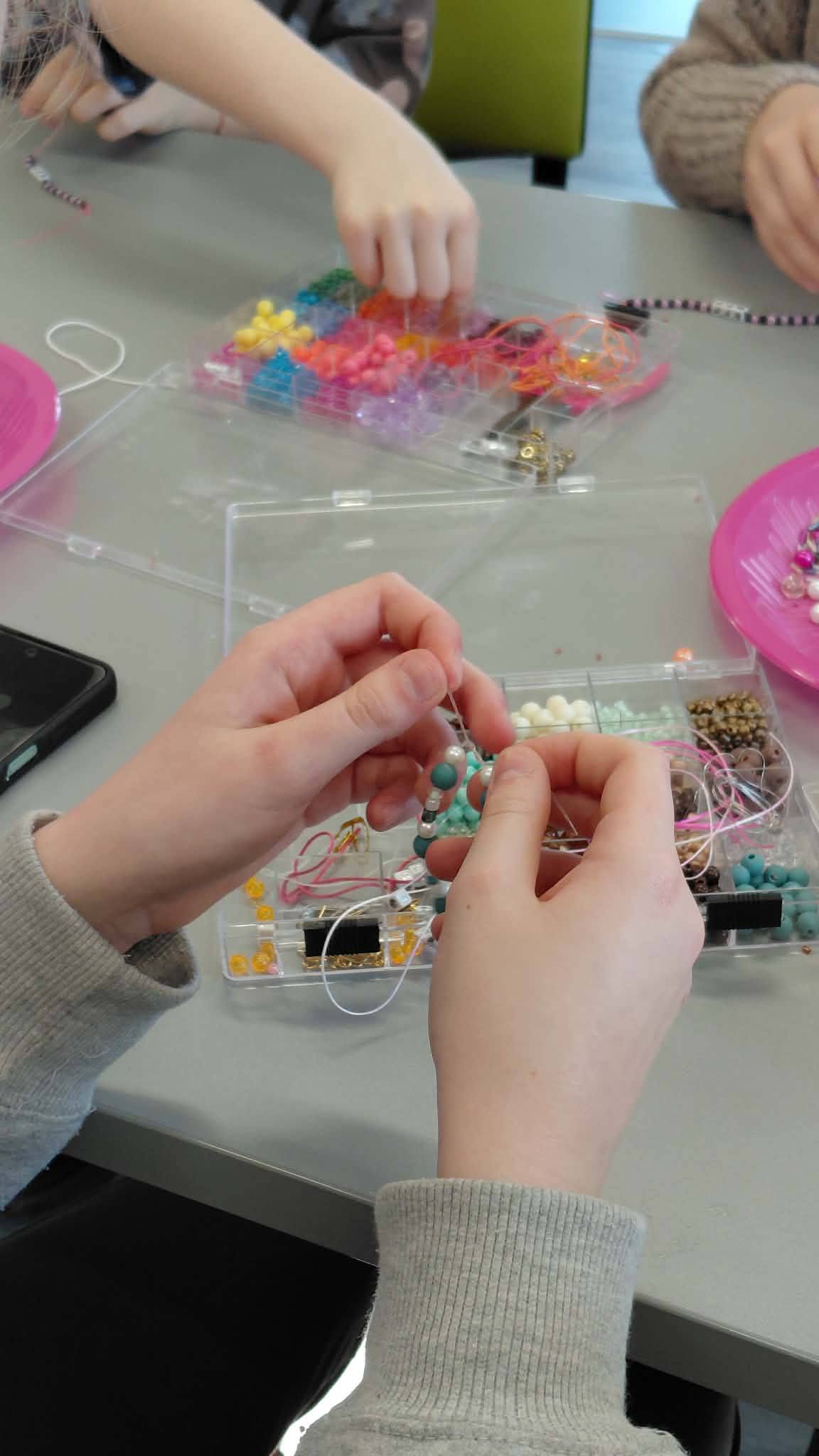 dzieci nawlekają koraliki