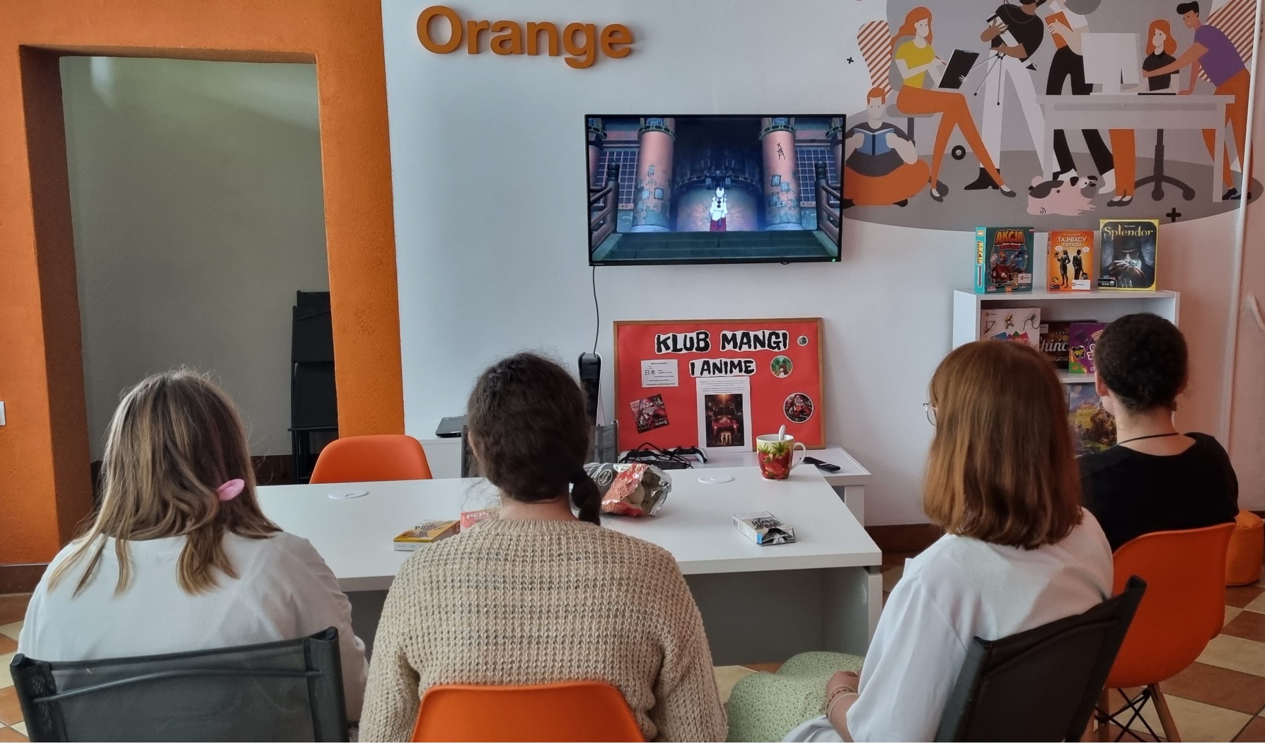 zdjęcie czwórki klubowiczów w trakcie oglądania filmu animowanego na ekranie telewizora