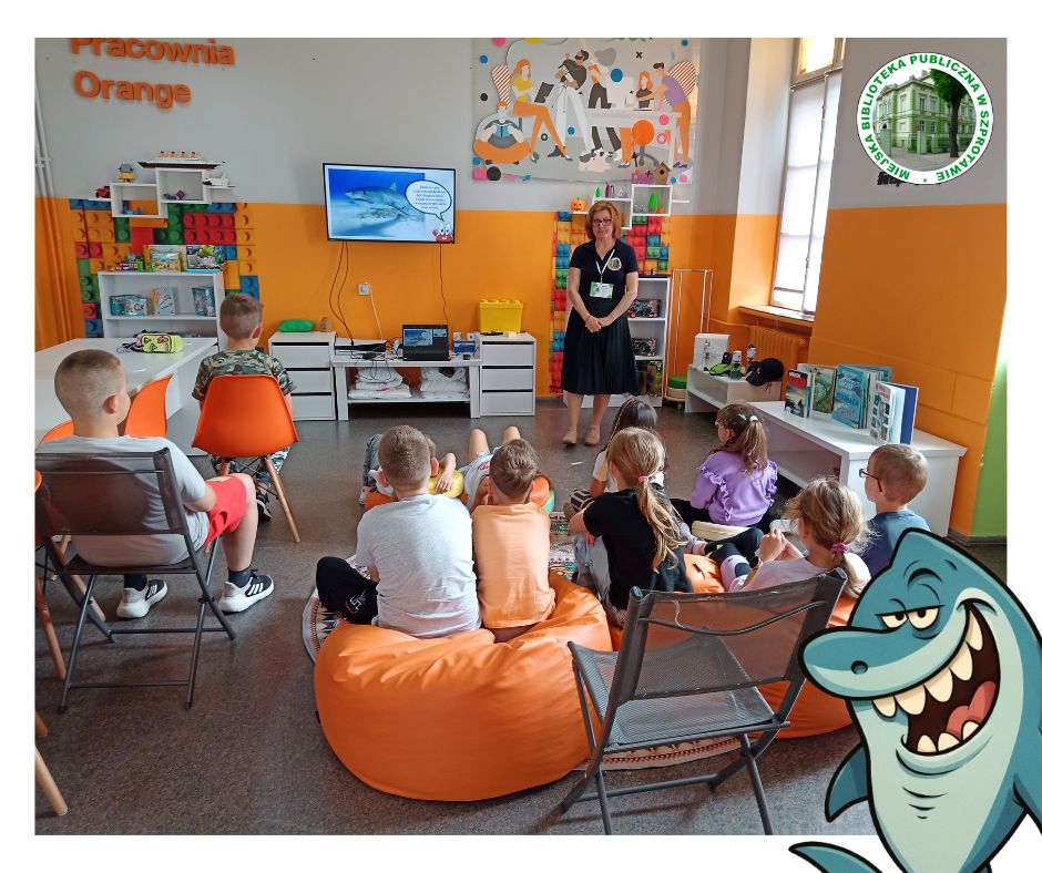 zdjęcie bibliotekarki i dzieci podczas prezentacji o rekinach, po prawej logo biblioteki i grafika rekina na dole