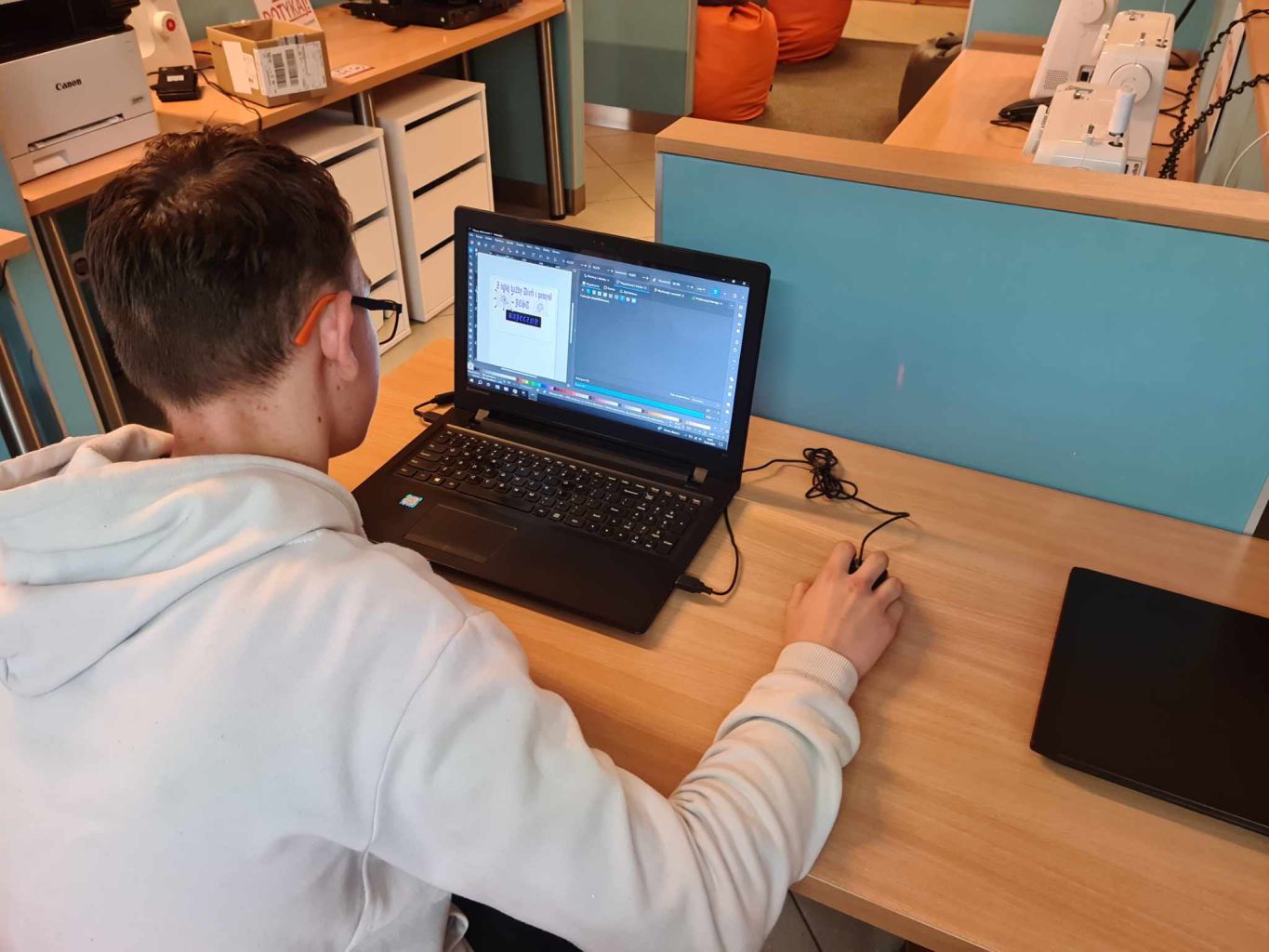 Chłopak korzystający z laptopa.