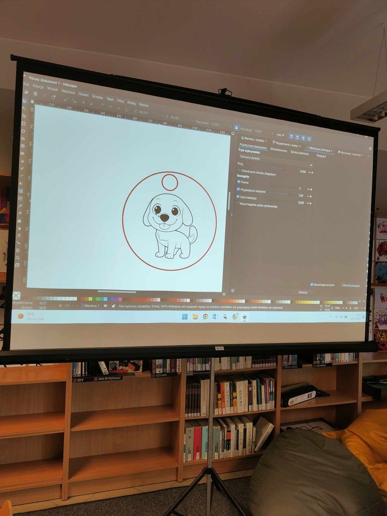 wyświetlany na ekranie projekcyjnym obraz przedstawiający widok na program do projektowania grafiki z ilustracją psa w czerwonym kółku