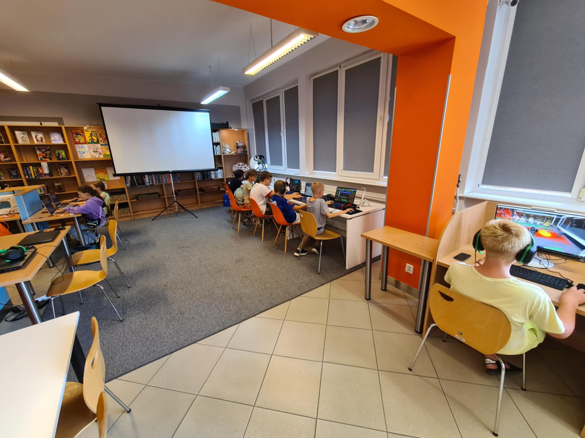 Dzieci grają i uczą się w ciszy przy komputerach w NASTCE z okazji Światowego Dnia Słuchania.
