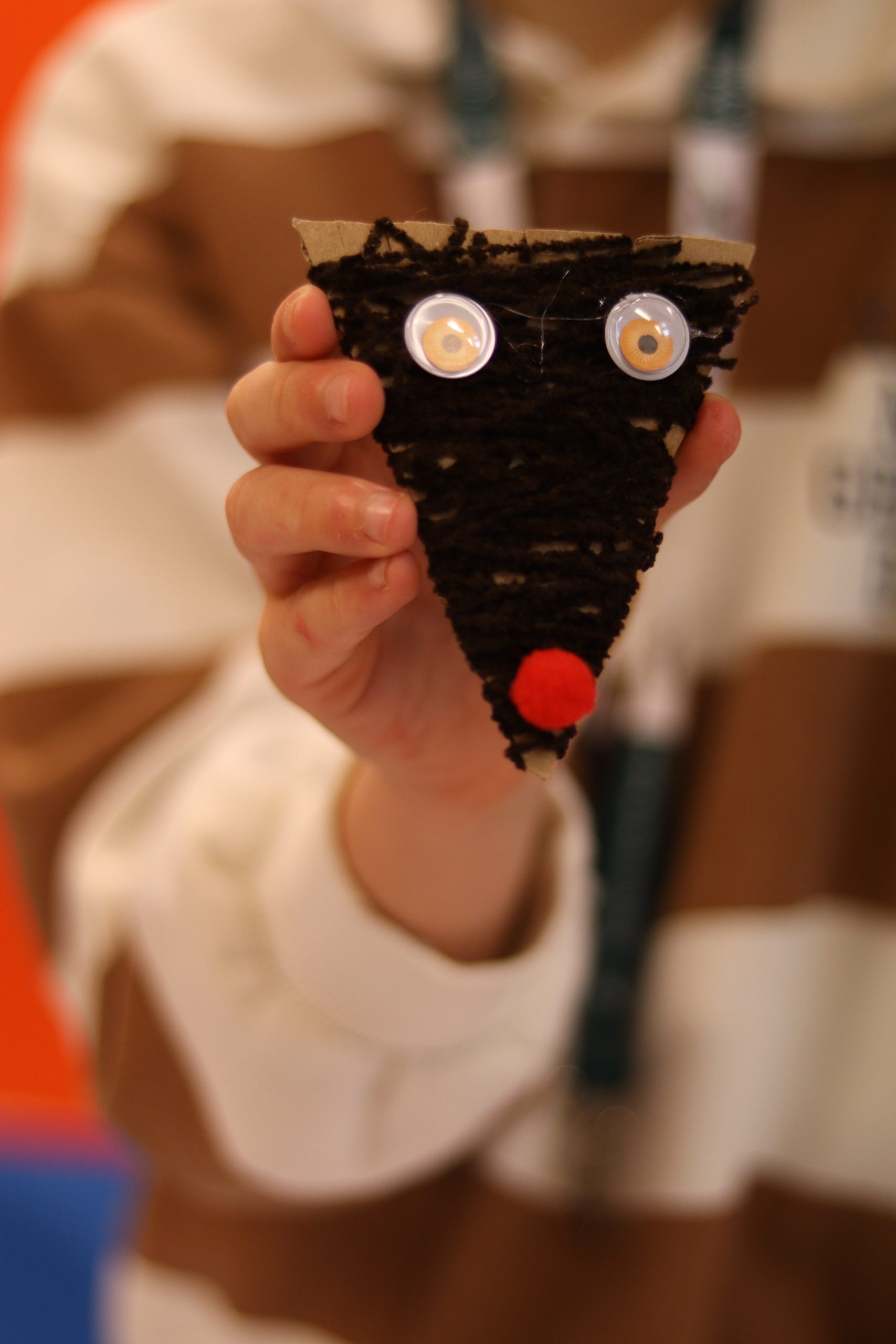 Dziecko prezentuje wykonane przez siebie zwierzątko.