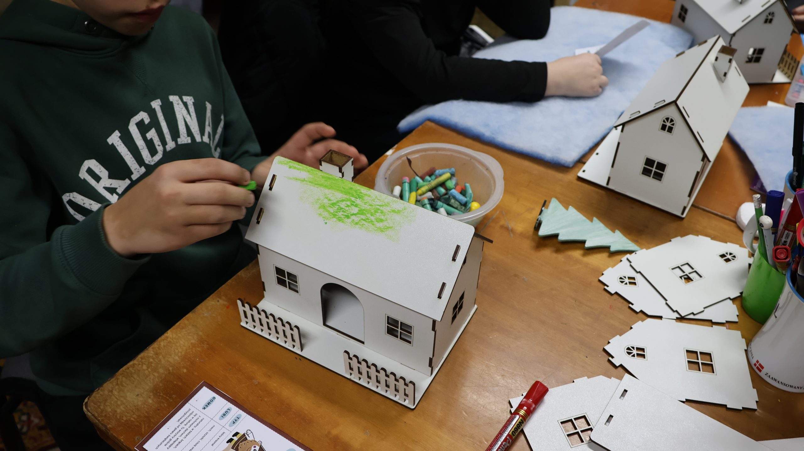 biały domek malowany na zielono