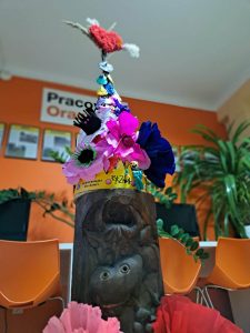 Zdjęcie przedstawia konstrukcję totemu ustrojoną w kolorowe kwiaty i emblematy wiosny.