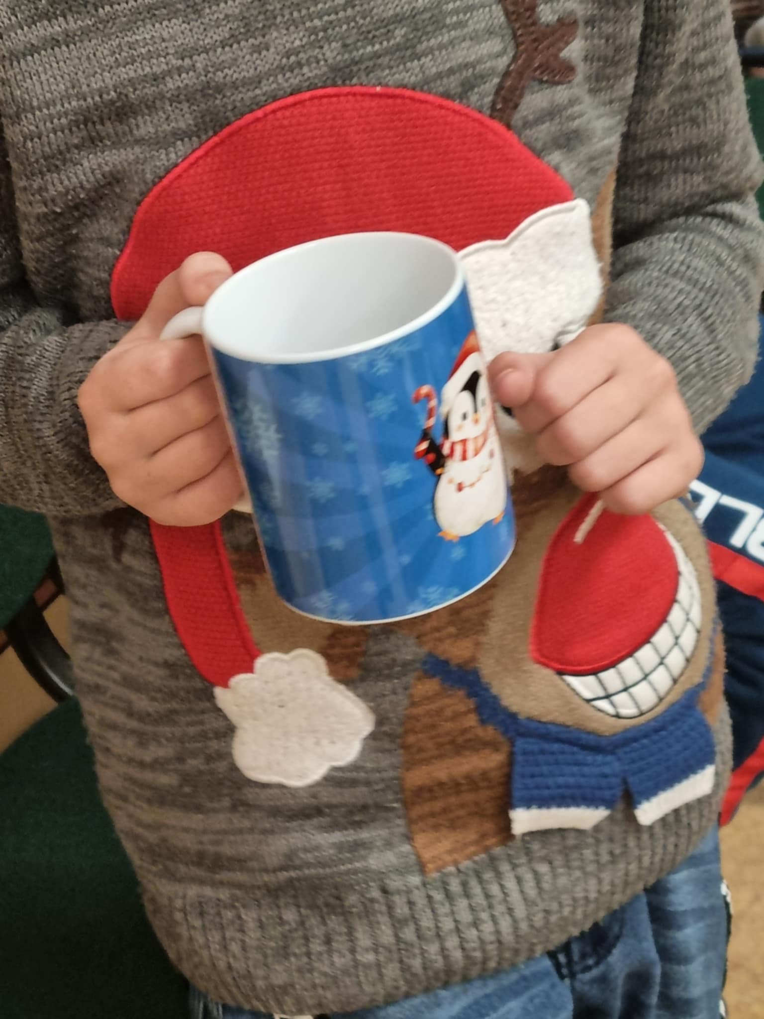na zdjęciu gotowy kubek z świątecznym nadrukiem pingwinka