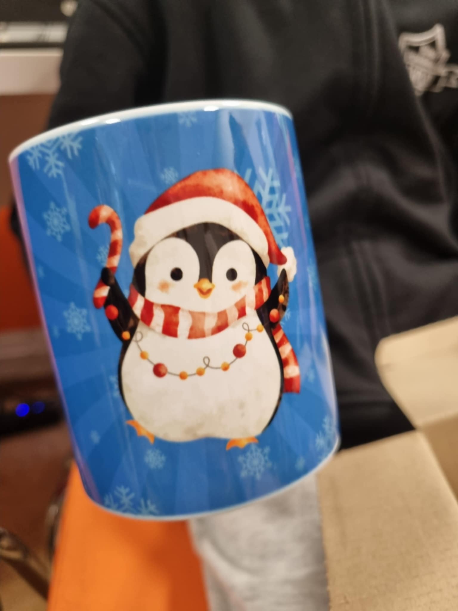 na zdjęciu gotowy kubek z świątecznym nadrukiem pingwinka
