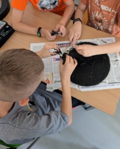 dzieci malujące koło z kartonu